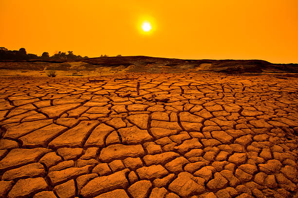 istock Sunset over cracked land and arid terrain 471837227