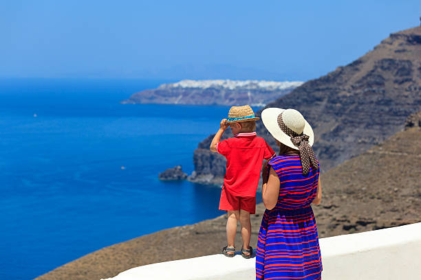 istock family looking at Santorini, Greece 471839239