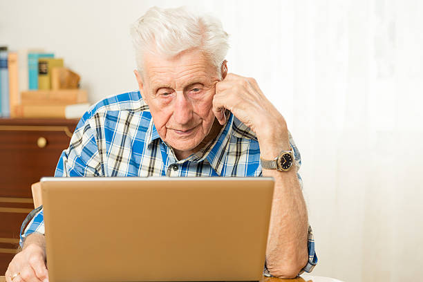 istock Senior man in front of a laptop computer 471839899