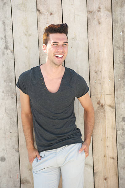 istock Attractive  young man laughing with hands in pocket 471840457