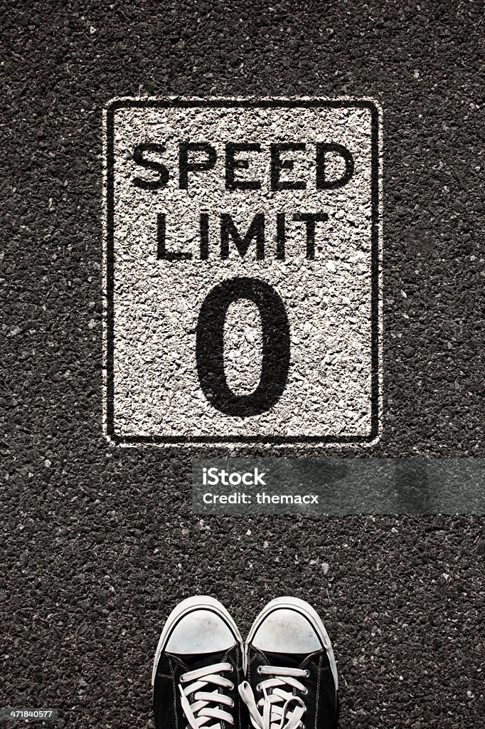 Speed Limit '0' Sign and Shoe Speed limit '0' sign and shoe on the asphalt. Speed Limit Sign Stock Photo