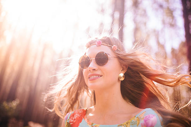 istock Boho girl in a summer forest with sun flare 471841326