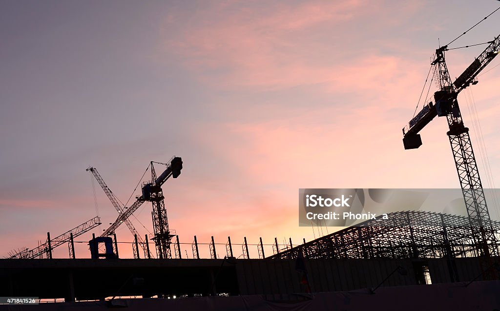 Cranes in the construction of large buildings. Cranes in the construction of large buildings with sunset. 2015 Stock Photo