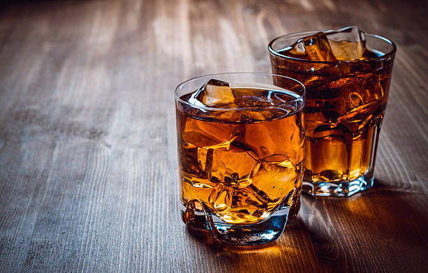 Cocktails Whiskey with ice on a wooden table amber black photography stock pictures, royalty-free photos & images