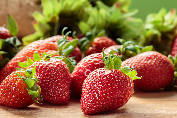 istock Strawberries on wooden board 471841760