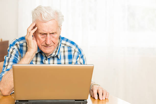 istock Senior man in front of a laptop computer 471842099