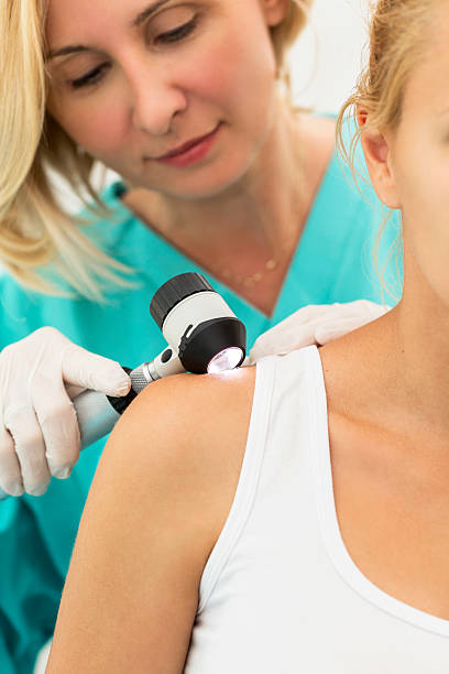 istock Dermatologist checking the shoulder of a female patient 471843005