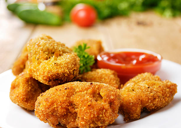 istock Fried chicken nuggets on the plate onto wooden table 471846479