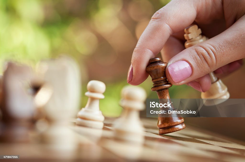 woman playing chess woman playing chess and hold queen Arts Culture and Entertainment Stock Photo