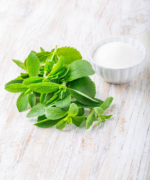 istock Fresh stevia leaves and bowl with sugar 471847496