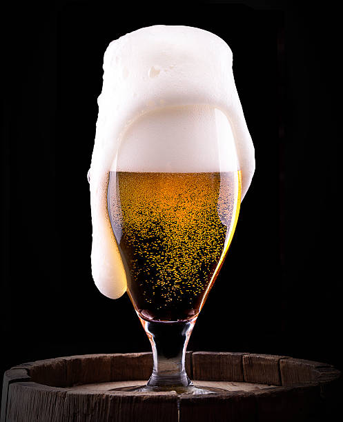 istock Frosty glass of light beer on black background 471849229