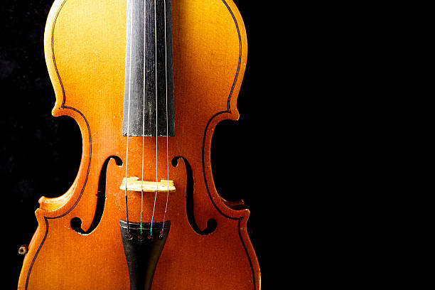 istock Close up of a violin isolated on black 471850394