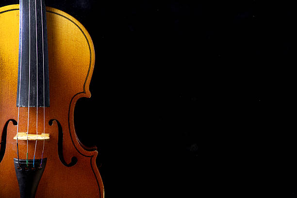 istock Close up of a violin isolated on black 471850398
