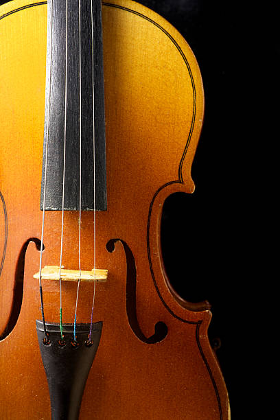 istock Close up of a violin isolated on black 471850406