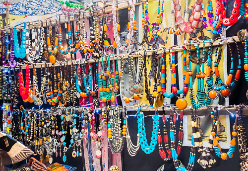 Cape Town, South Africa - November, 23rd 2014: African necklace curios on display at the market in Hout Bay. The Bay Harbour market is a popular outing destination for Cape Town tourists with all food delicacies and crafts on display by various traders.