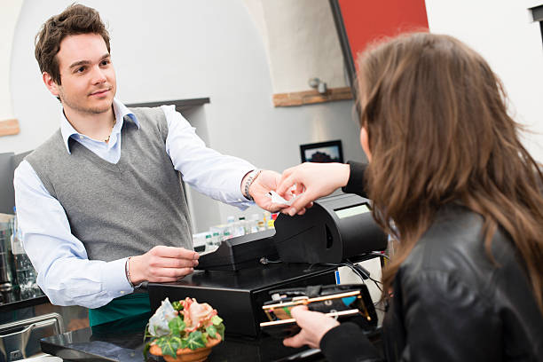 istock Young woman paying at the restaurant 471850757