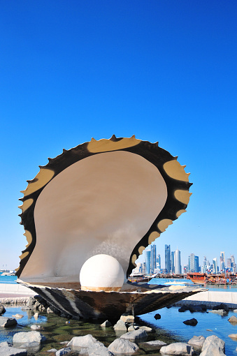 Doha, Qatar: Pearl and Oyster Fountain - south end of the Corniche - West Bay skyline in the background - plenty of copy space for text - photo by M.Torres