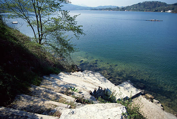 Stairs down to the Aiguebelette's lake and rowers in the background, Savoy, France