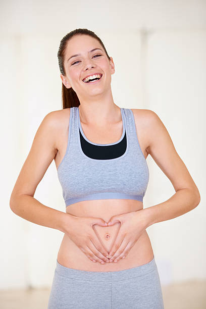 trimming down her belly fat - matsmältningsorgan bildbanksfoton och bilder