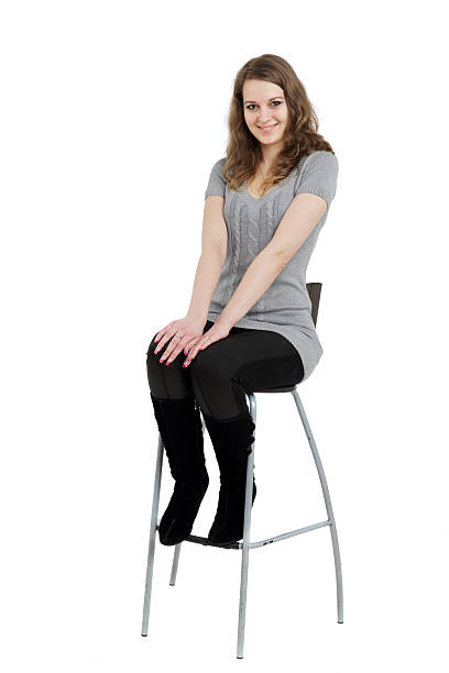 istock Smiling woman sitting on chair 471852371