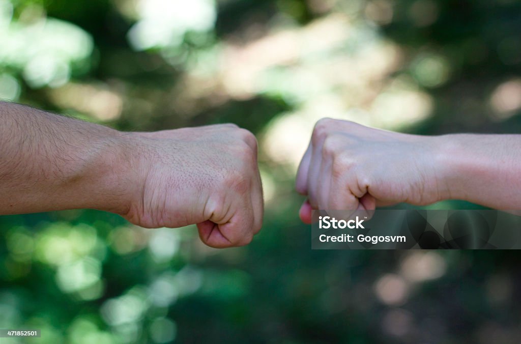 Opposition Two opposing male/female fists Fist Stock Photo