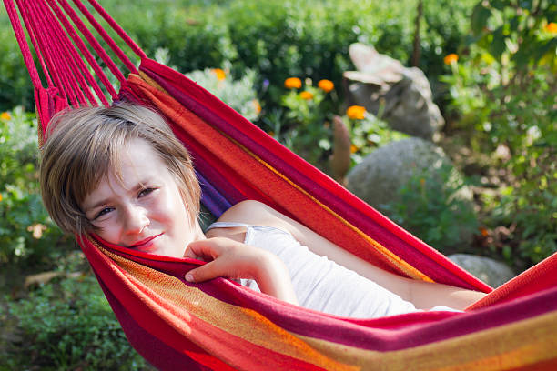 istock Lovely girl resting in a hammock 471854928