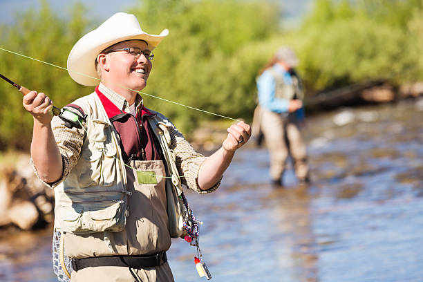 istock Fly fisherman casting line while fishing in river 471856143