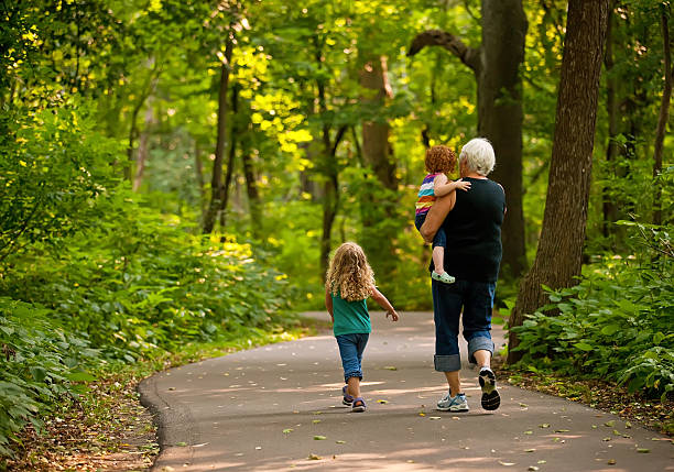 oma & graunddaughters auf park trail - family walking child toddler stock-fotos und bilder