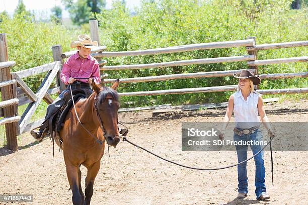 Rancher And Young Son Training Horse In Corral Stock Photo - Download Image Now - Adult, Agriculture, Animal