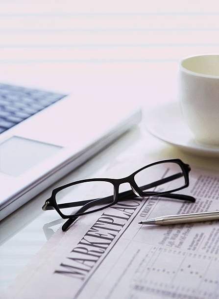 istock glasses and news paper 471857751