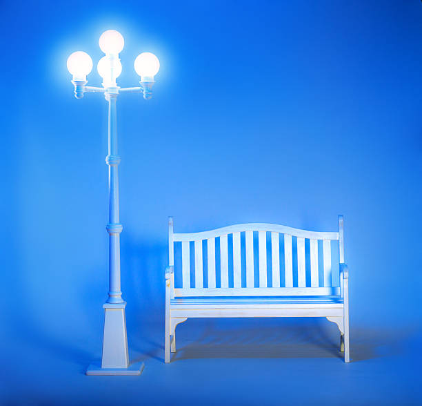 Bed with cushions illuminated by red lamp