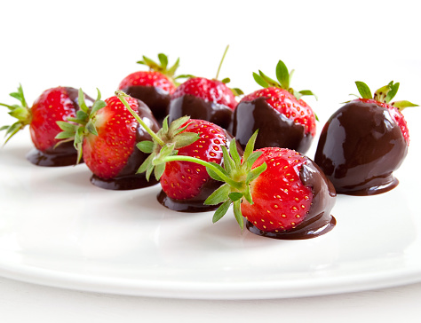 Strawberries dipped in delicious chocolate isolated on the white background