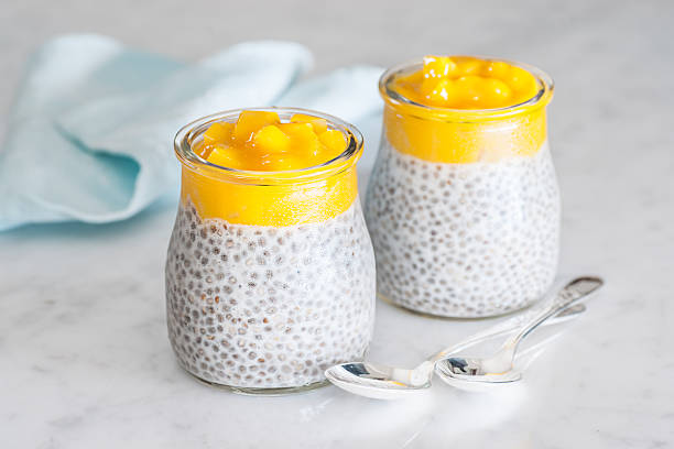 Coconut and mango chia seeds pudding with spoons stock photo