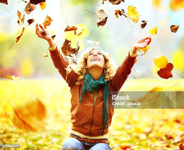 Cheerful Woman Enjoying Autumn Day In Park Stock Photo - Download Image Now - Leaf, Throwing, Adult