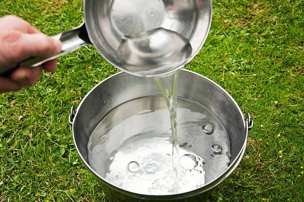 istock Pouring fresh water from ladle into a bucket. 471862057