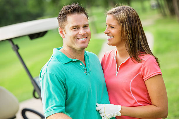 istock Happy husband and wife playing golf together 471862499