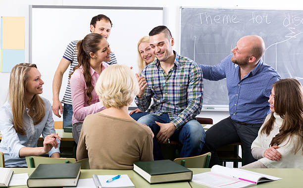 istock Teacher and happy adult students 471862888