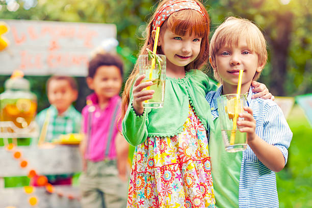 istock Lemonade stand and children 471865839