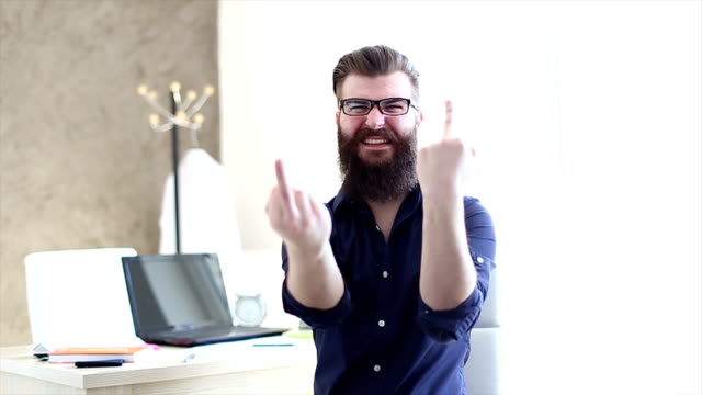 Bearded hipster businessman showing middle finger .