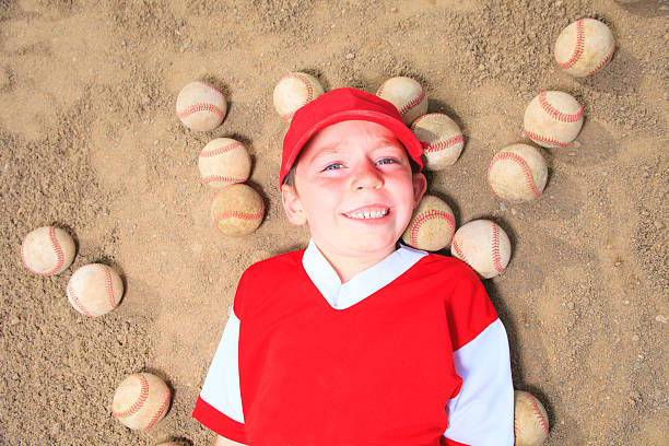 baseball-ball boy lay - batting gloves stock-fotos und bilder