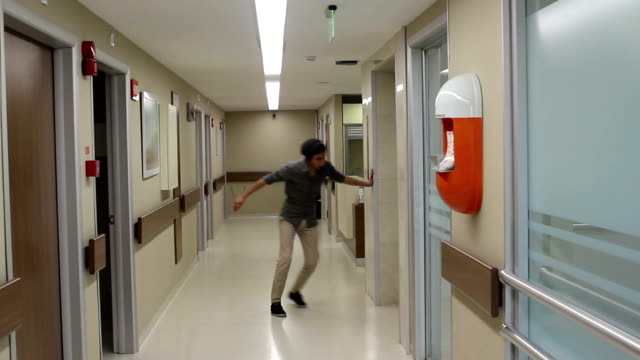 Sick man walking in corridor of hospital