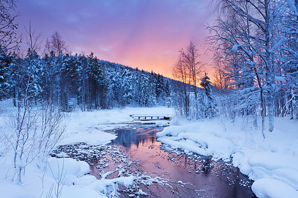 Sunrise over a river in winter near Levi, Finnish Lapland A river in a wintry landscape. Photographed near Levi in Finnish Lapland at sunrise. finnish lapland stock pictures, royalty-free photos & images