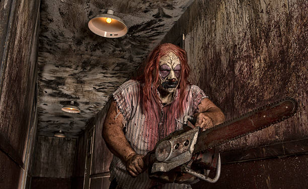 istock Serial Killer Clown holding chain saw 471867701