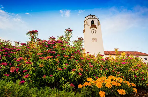 Unique view of Boise Train Depot in Boise, Idaho, USA on a fine summer morning with flowers blooming in the foreground and blue sky in the background