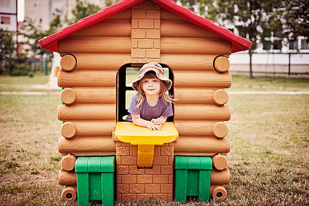 Little boy playing in the playhouse stock photo