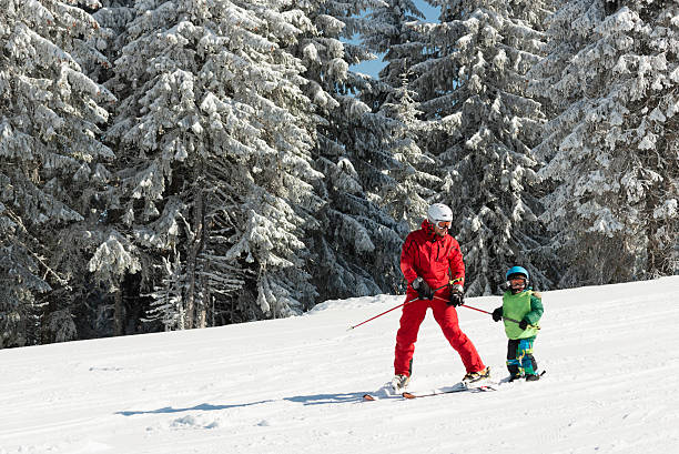 Skiing lesson Individual skiing lesson, instructor and little boy on a slope ski instructor stock pictures, royalty-free photos & images