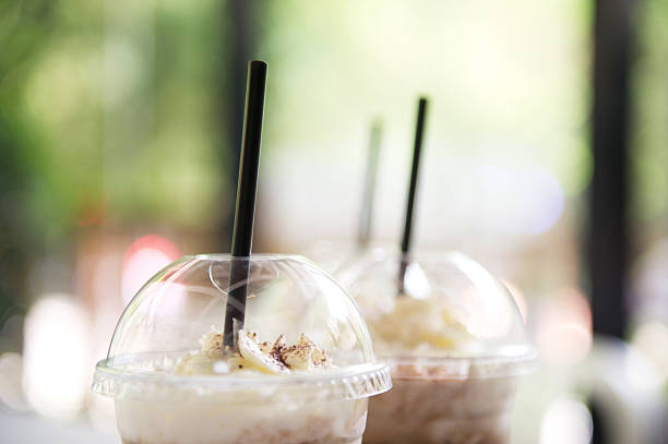 Two takeaway cup of iced coffee with whipped cream