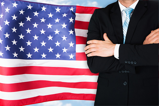 Close-up Of Businessman In Front Of American Flag