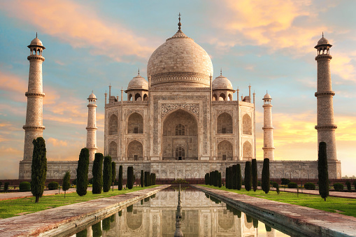 The magnificent Taj Mahal in India shows its full splendor at a glorious sunrise with pastel-colored sky