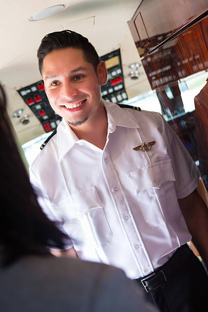 istock Commercial jet pilot talking with flight attendant in cockpit 471872921